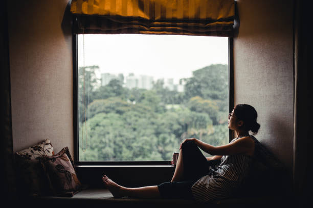 istock woman looking at a window 1132146353