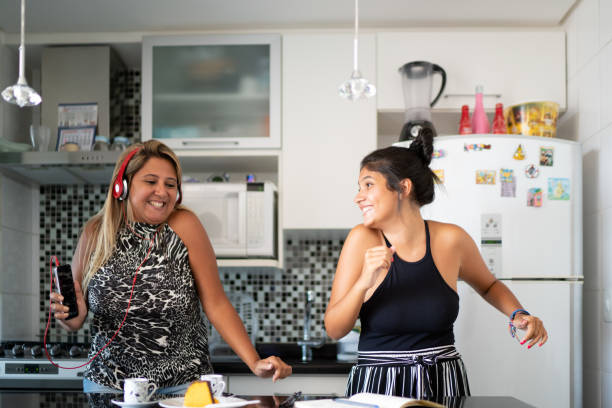 istock Mother and daughter having fun together while dancing in the kitchen 1132147460