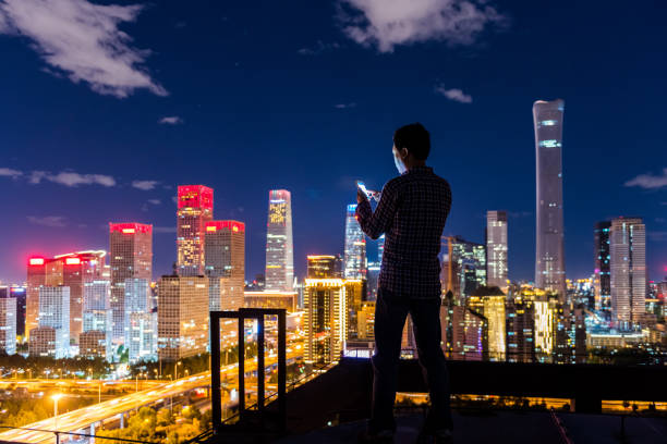 istock Business man with Smart Phone on rooftop 1132147562