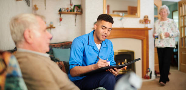 istock senior man with health visitor 1132147629