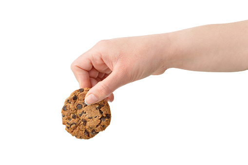 Woman holding a chocolate cookie with blank background