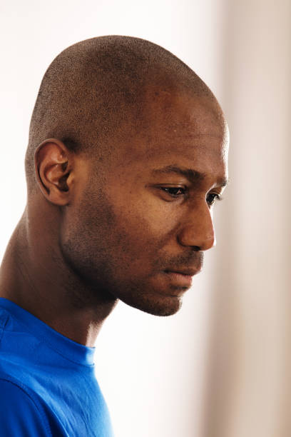 istock Bald mature pensive black man back lit profile head shot 1132150452