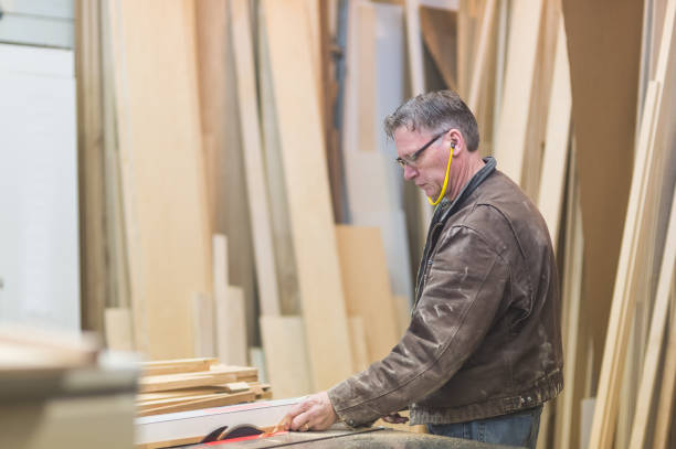 istock Master woodworker measuring wood for cabinets in his shop 1132152649