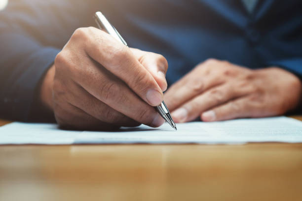 istock businessman writing on paper report in office 1132162879