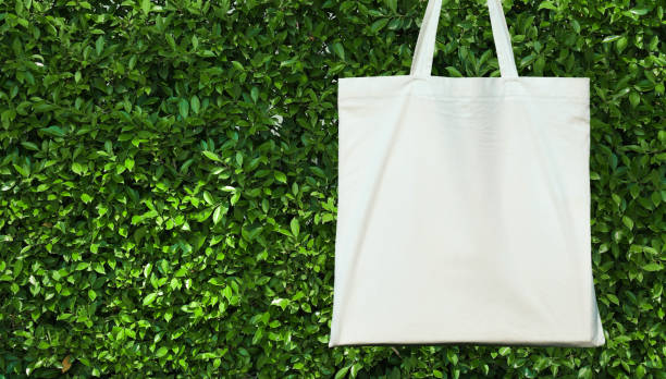 istock blank white cotton bag on green leavs background. eco friendly concept 1132162939