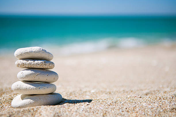 Stack of white stones on tropical beach stock photo