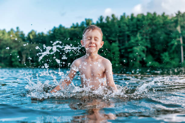 boy splashes in the lake