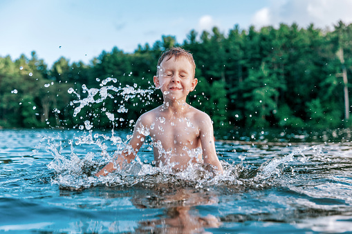 happy kid playing in the water