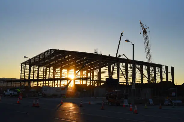 Frame of hangar being built at Los Angeles International Airport at sunrise.