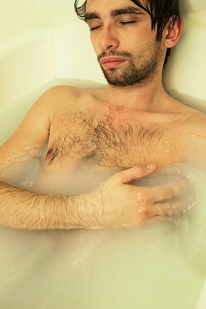 istock young sexual tanned naked guy in bath 113217197