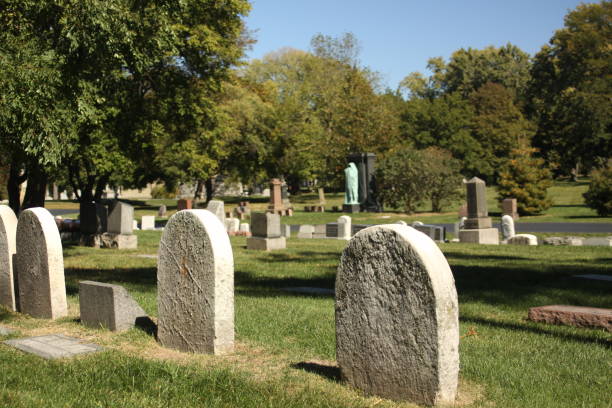 istock old headstones, cemetery and blue sky 1132175526
