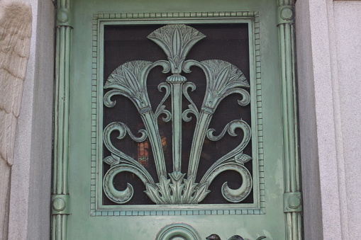 ornate  iron grate, green patina