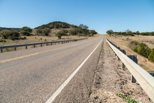 istock Low Angle View of Small Road Going Up Hill in a Clear Day 1132176712