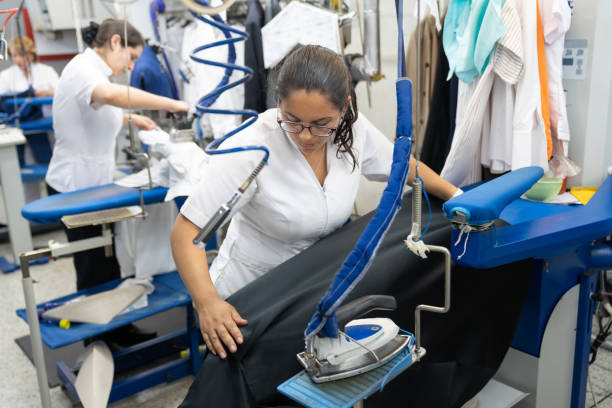 istock Women working at a laundry service ironing clothes 1132178357