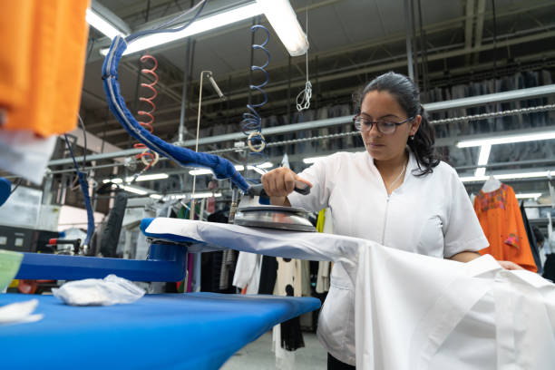 istock Latin american young woman working at a laundry service ironing clothes 1132178361