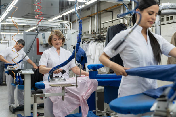 istock Group of workers at a laundry service ironing clothes 1132178369