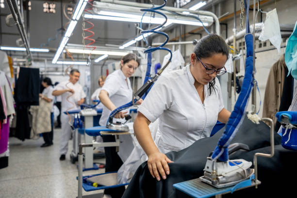 istock Latin american women at a laundry service ironing different garments 1132178377