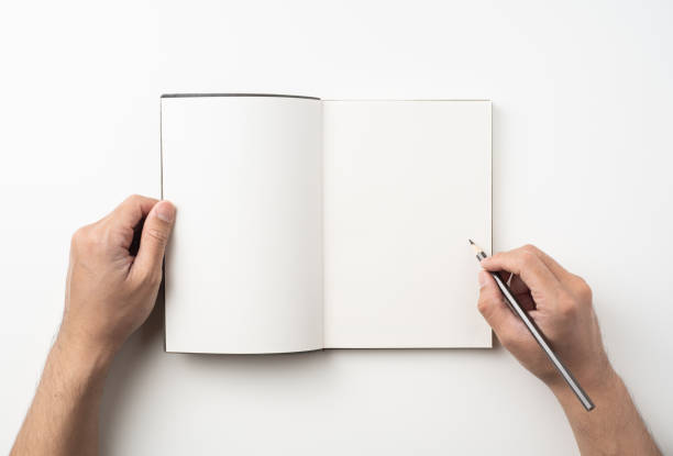 istock man hand hold brown notebook and pen on white 1132182609