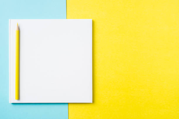 istock white square notebook on yellow and blue paper 1132182989