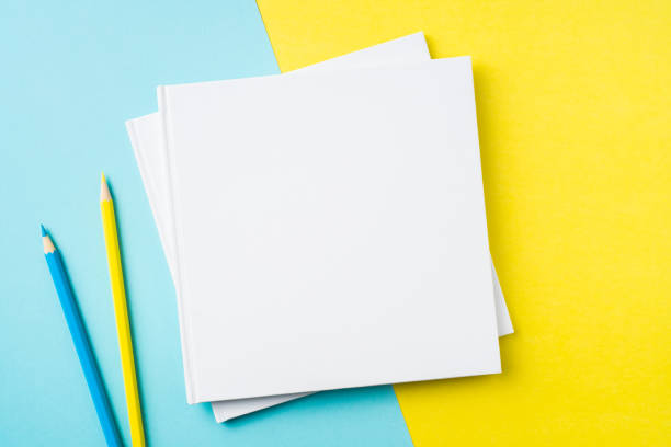istock two white square notebook on yellow and blue paper 1132183014