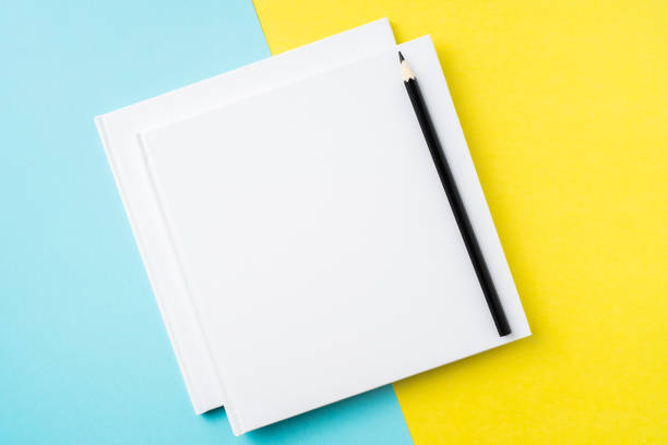 istock two white square notebook on yellow and blue paper 1132183025
