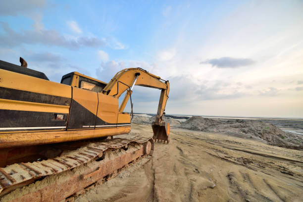 istock Large excavator under the blue sky white cloud features of artistic expression 1132183695