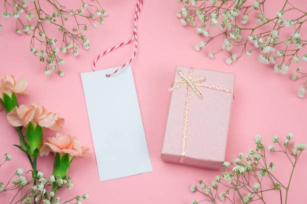 istock floral  frame with mock up empty label and gift box pink background 1132183890