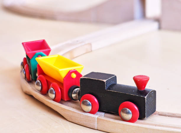 istock Wooden toy train running on miniature railroad 1132185165