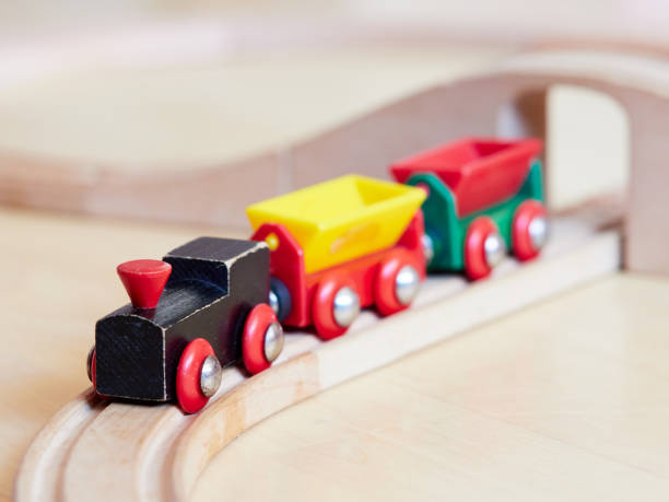 istock Wooden toy train running on miniature railroad 1132185209