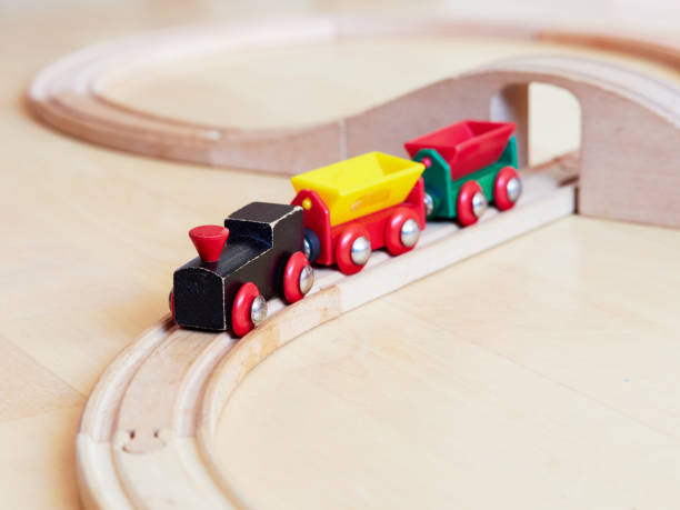 istock Wooden toy train running on miniature railroad 1132185372