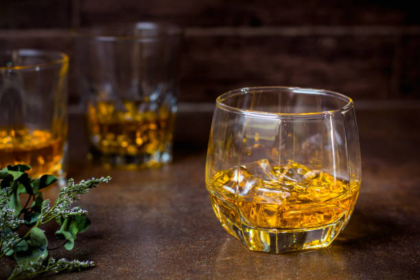 istock glasses of whiskey with ice cubes  on  bar. 1132187871