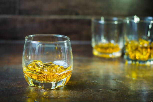 istock glasses of whiskey with ice cubes  on  bar. 1132187914