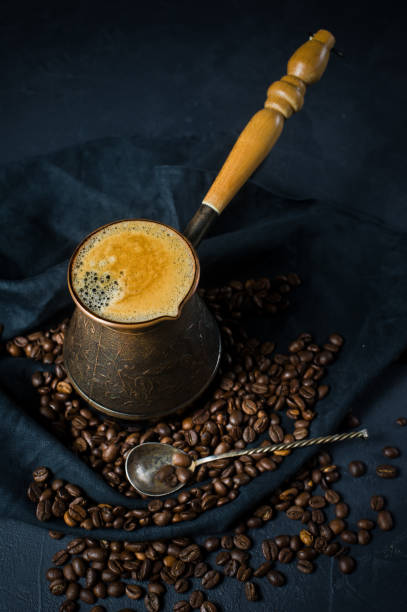 istock Turkish coffee in a cezve, the Breakfast. Black background, top view, space for text. 1132191412
