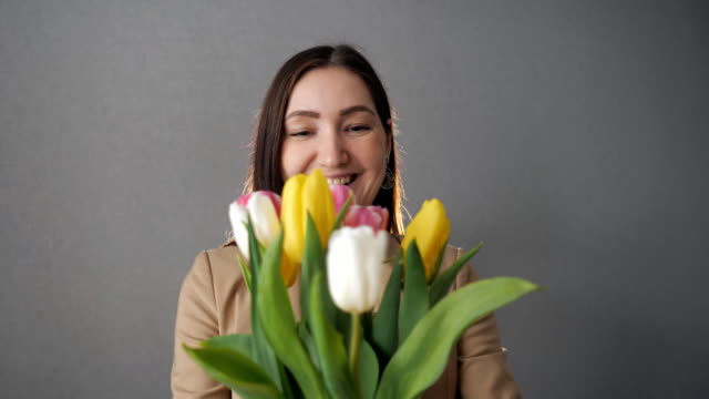 Beautiful woman gets bouquet of tulips