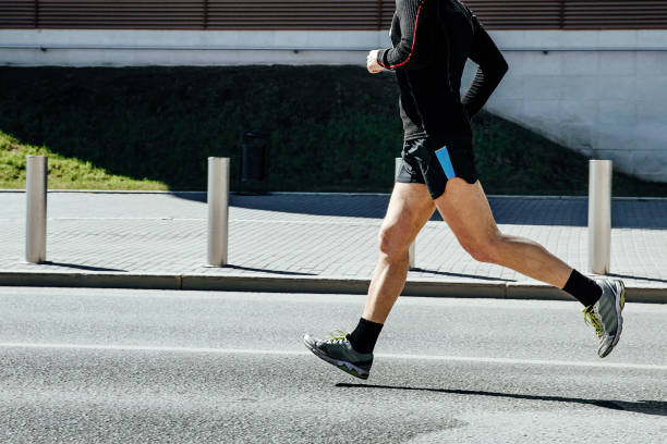 side view male runner in black sportswear