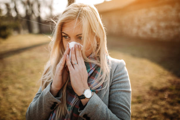 istock Sick blonde blowing her nose 1132193999