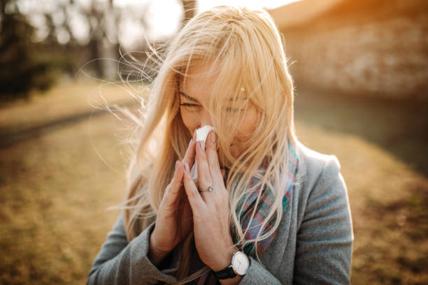 istock Sick blonde blowing her nose 1132194660