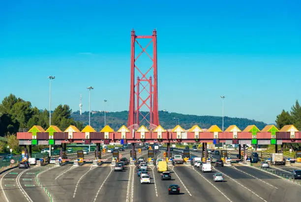 Photo of Toll station at the entrance to the 25th April Bridge between Lisbon and Almada, Portugal. Cars passing through pay station