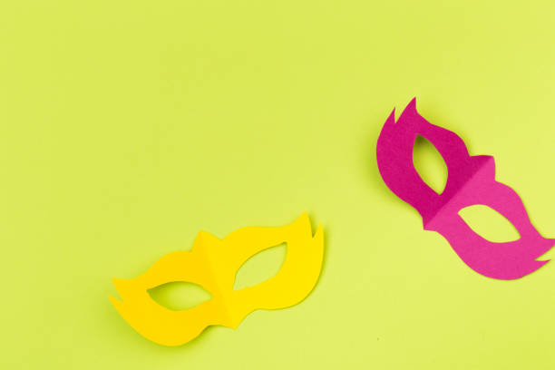 istock cut out colored paper figures for the holiday Mardi Gras, colour background 1132201650