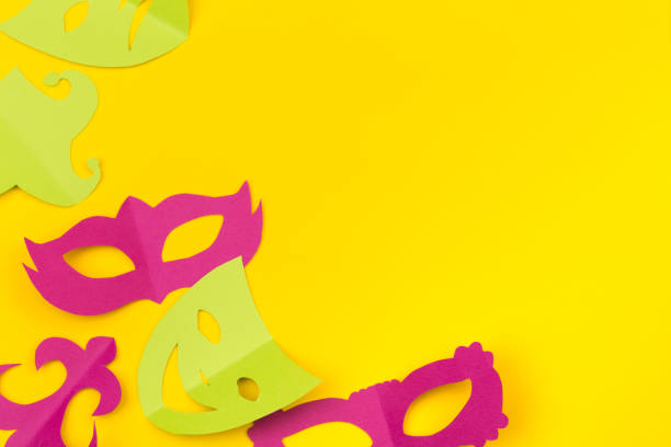 istock cut out colored paper figures for the holiday Mardi Gras, colour background 1132201653