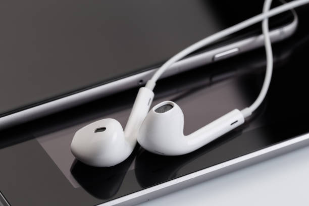 istock white earphones on tablet and phone 1132202822