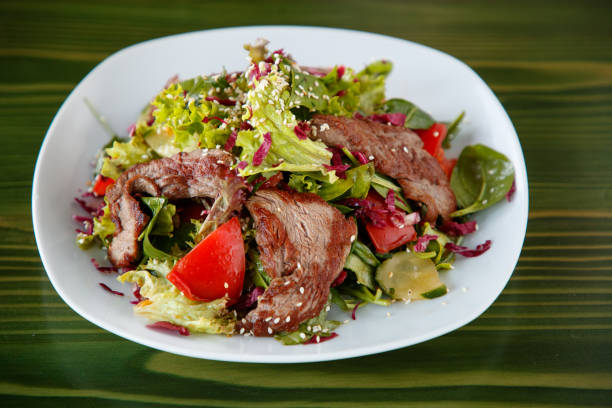 Serving size of steak salad with vegetables and sesame