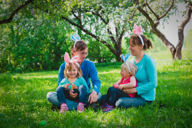 istock happy mom and dad with kids on easter eggs hunt in spring 1132204217