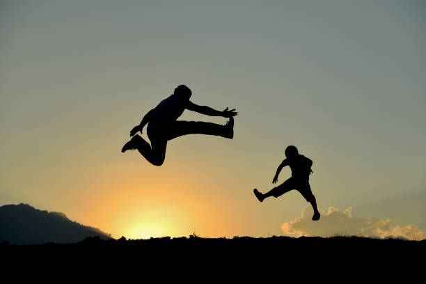 istock energetic father and son silhouette 1132204619