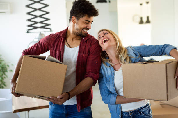 istock Young couple unpacking cardboard boxes at new home moving in concept 1132205617