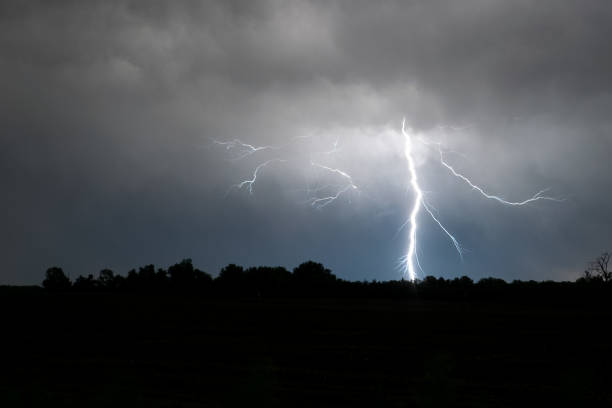 istock A bright lightning bolt with many side branches strikes down to earth. 1132207065