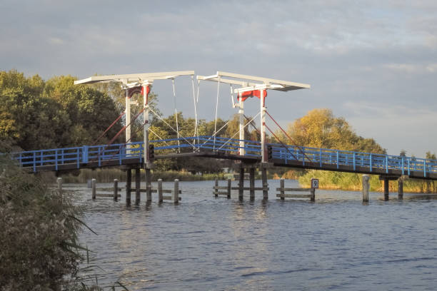 istock Old drawbridge over a river in The Netherlands in autumn 1132207219