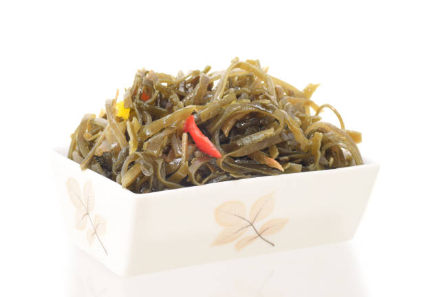 Laminaria salad or sea in plate isolted on white