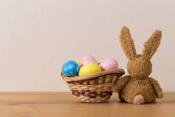 istock Easter bunny rabbit with  painted egg on wooden background. Easter holiday concept. 1132208941