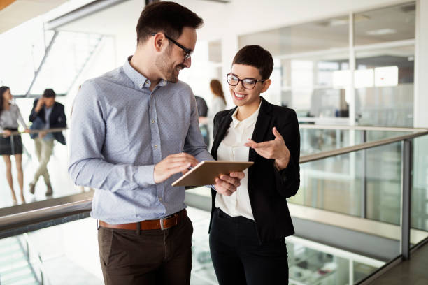 istock Happy young business colleagues in modern office 1132209175